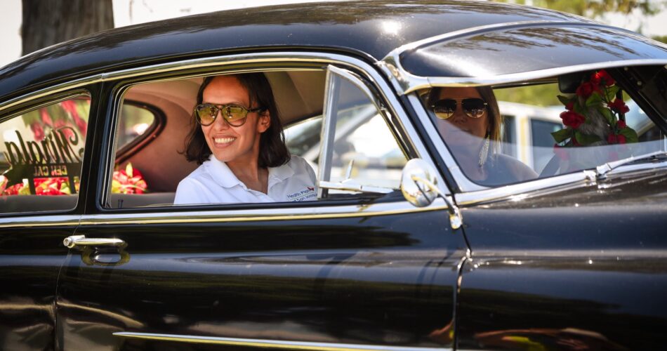 Health Plan of San Joaquin CEO Lizeth Granados riding in a vehicle at a car show.