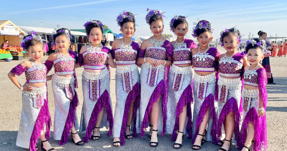 A group of young women wearing clothing from their heritage for a Health Plan event.