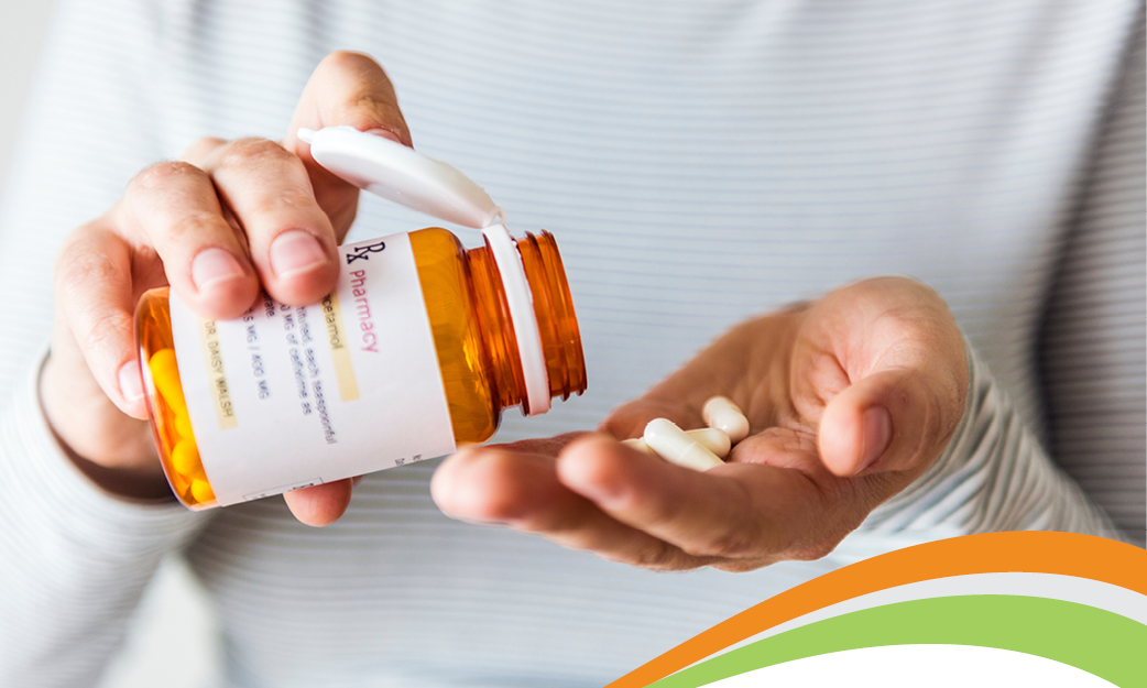 A health care member opening medication they purchased through their health plan